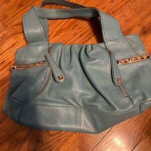 Teal colored leather purse in excellent condition. magnetic snap closure.